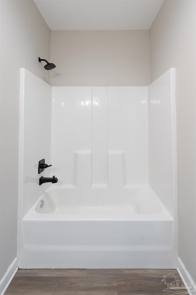 9901 Raymar St Unit A, Pensacola, FL 32534 - bathroom with bathing tub / shower combination, baseboards, and wood finished floors