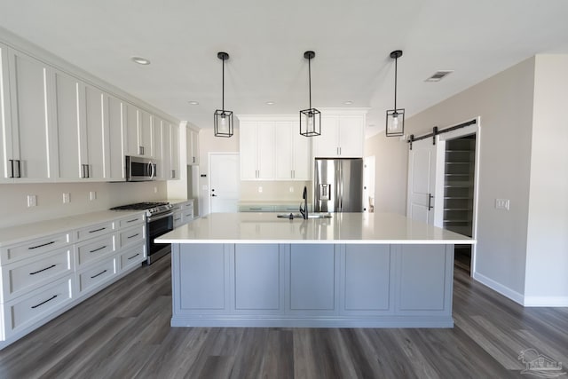 9901 Raymar St Unit A, Pensacola, FL 32534 - kitchen with dark wood finished floors, visible vents, a barn door, a sink, and stainless steel appliances