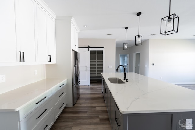 9901 Raymar St Unit A, Pensacola, FL 32534 - kitchen featuring stainless steel refrigerator with ice dispenser, a barn door, dark wood-type flooring, a spacious island, and a sink