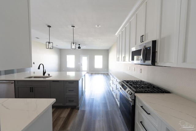 9901 Raymar St Unit A, Pensacola, FL 32534 - kitchen with pendant lighting, dark wood-type flooring, a sink, stainless steel appliances, and open floor plan
