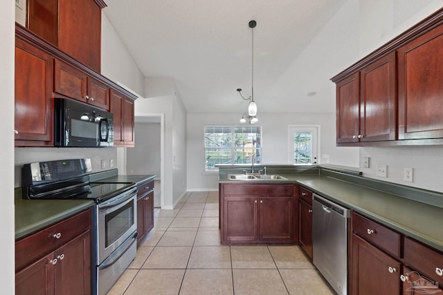 kitchen with appliances with stainless steel finishes, dark countertops, decorative light fixtures, and reddish brown cabinets