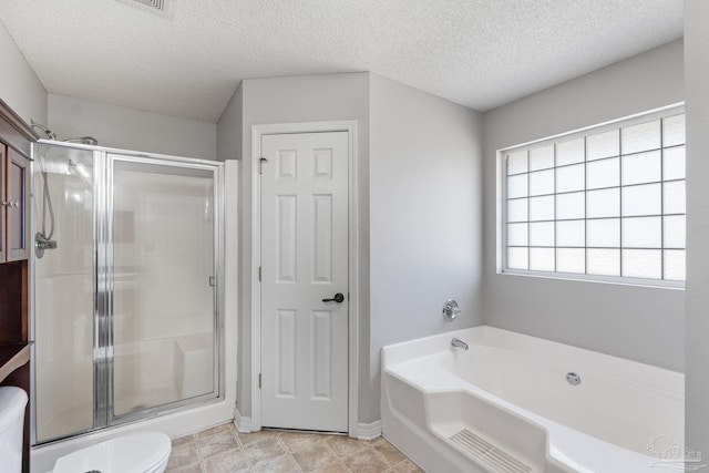 bathroom with toilet, a stall shower, a garden tub, and a textured ceiling