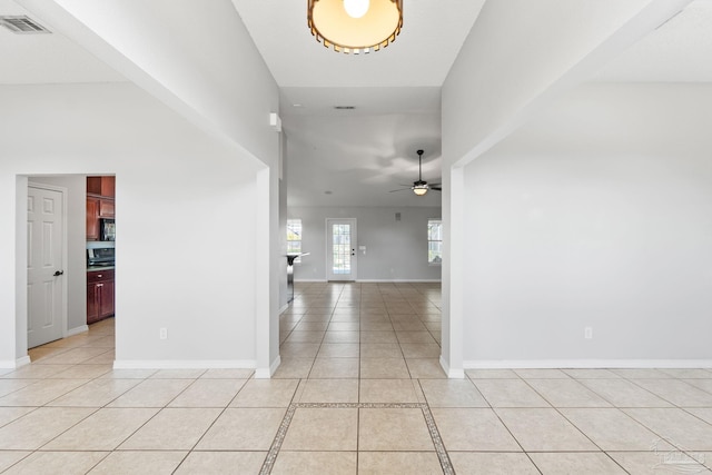 entryway featuring light tile patterned floors, visible vents, baseboards, and ceiling fan