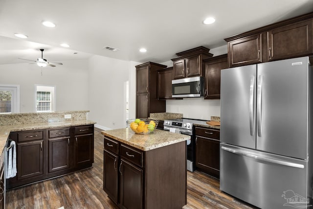 kitchen with dark brown cabinets, appliances with stainless steel finishes, dark wood-style flooring, and visible vents