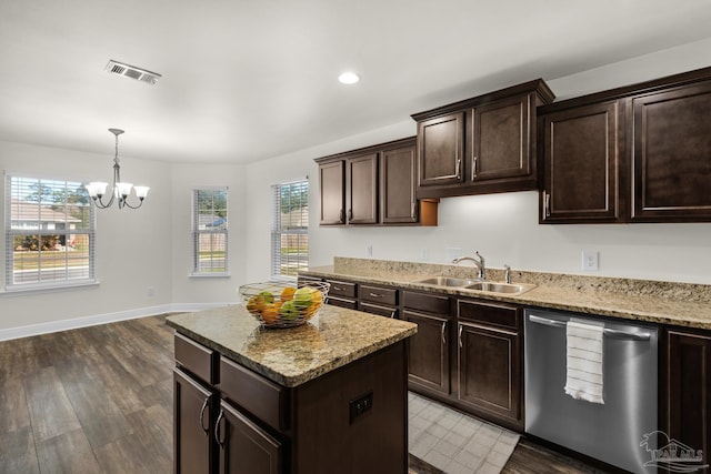 kitchen with wood finished floors, a sink, visible vents, a center island, and dishwasher