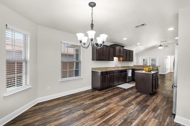 kitchen featuring dark brown cabinetry, visible vents, dark wood-type flooring, stainless steel dishwasher, and a sink