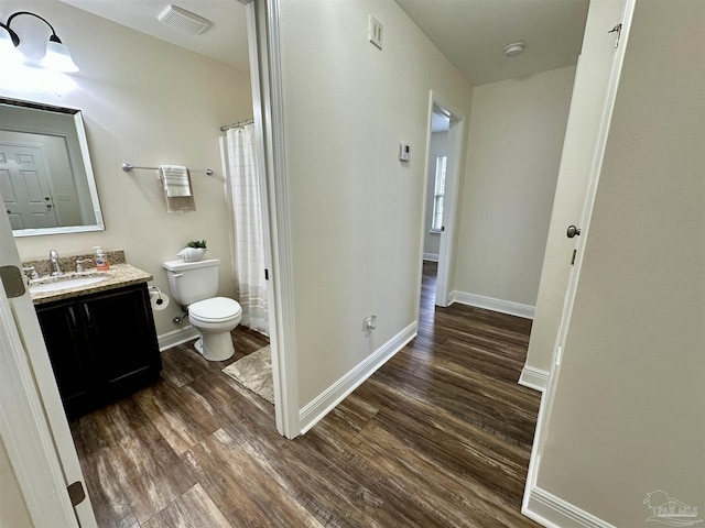 full bath with visible vents, wood finished floors, toilet, and baseboards