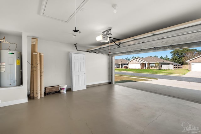 garage featuring water heater, baseboards, and a garage door opener