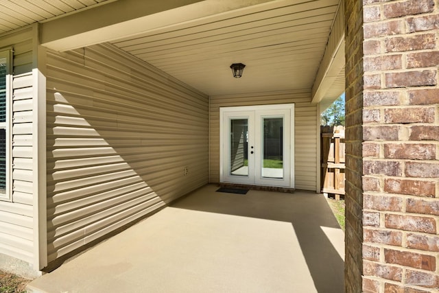 view of exterior entry with french doors and brick siding