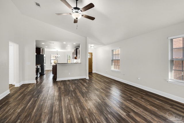 unfurnished living room with dark wood-style floors, baseboards, visible vents, and vaulted ceiling