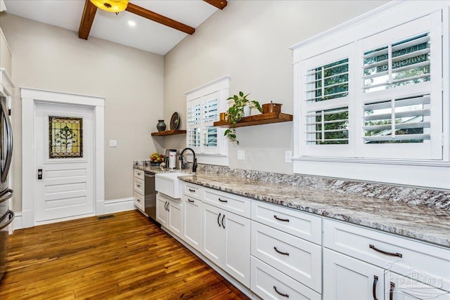 kitchen with dark wood-type flooring, sink, white cabinetry, beamed ceiling, and light stone countertops