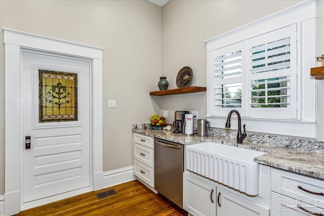 kitchen featuring sink, white cabinetry, dark hardwood / wood-style floors, light stone counters, and stainless steel dishwasher