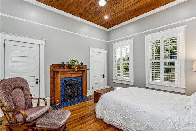 bedroom with hardwood / wood-style flooring, ornamental molding, and wood ceiling