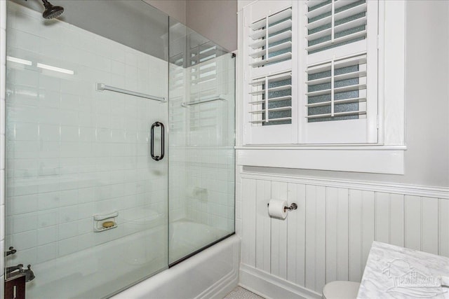 bathroom with shower / bath combination with glass door