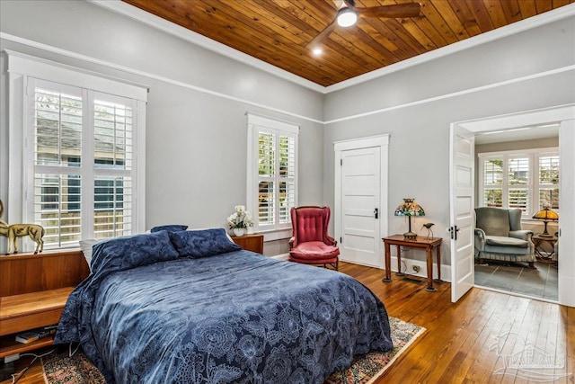 bedroom with multiple windows, wood ceiling, crown molding, and hardwood / wood-style flooring