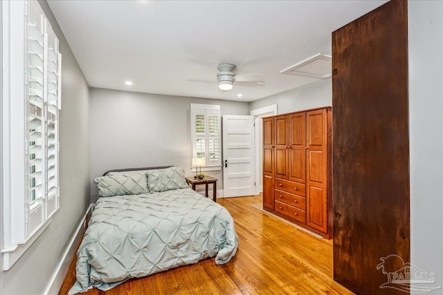 bedroom with light hardwood / wood-style floors and ceiling fan