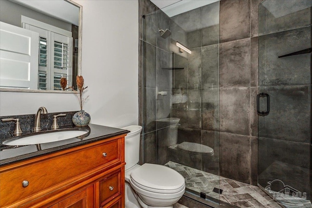 bathroom featuring walk in shower, vanity, and toilet