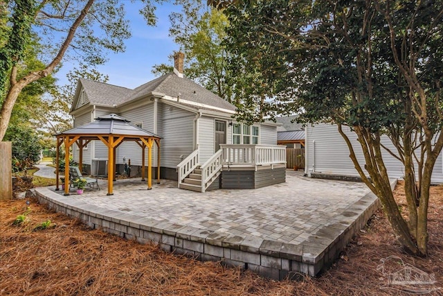 back of property featuring a gazebo, central AC, and a patio