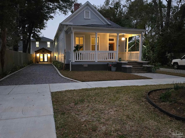 view of front facade with covered porch and a front lawn