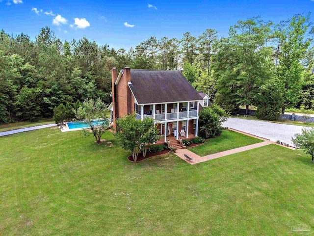 607 Goodwill Cir, Silas, AL 36919 - view of front of house with an outdoor pool, a front yard, a porch, and a chimney