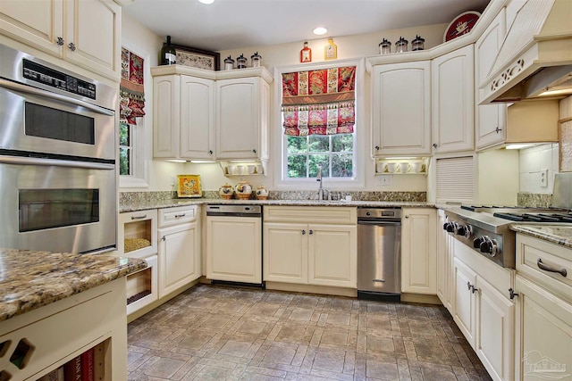 607 Goodwill Cir, Silas, AL 36919 - kitchen with custom range hood, appliances with stainless steel finishes, a sink, light stone counters, and recessed lighting