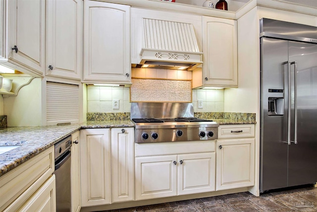 607 Goodwill Cir, Silas, AL 36919 - kitchen with appliances with stainless steel finishes, premium range hood, decorative backsplash, and light stone counters