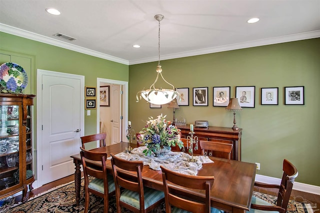 607 Goodwill Cir, Silas, AL 36919 - dining area featuring wood finished floors, crown molding, recessed lighting, and baseboards