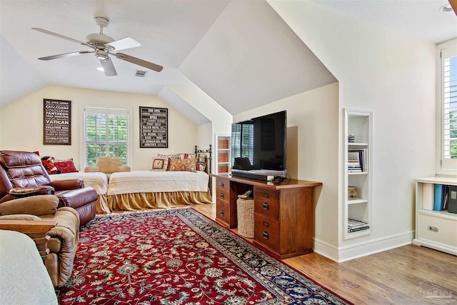 607 Goodwill Cir, Silas, AL 36919 - living room featuring wood finished floors, vaulted ceiling, ceiling fan, built in features, and baseboards