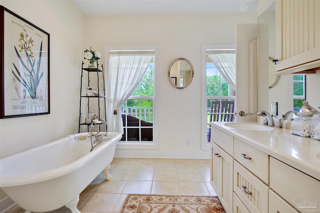 607 Goodwill Cir, Silas, AL 36919 - bathroom featuring tile patterned flooring, a freestanding bath, vanity, and baseboards
