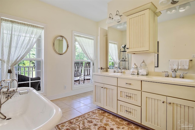 607 Goodwill Cir, Silas, AL 36919 - bathroom with a freestanding tub, double vanity, and tile patterned flooring