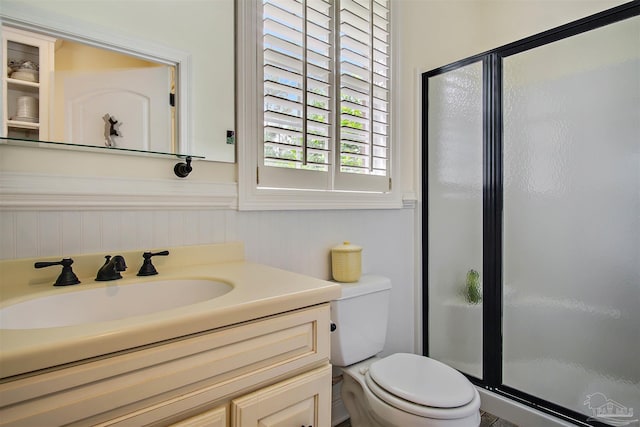 607 Goodwill Cir, Silas, AL 36919 - bathroom featuring a stall shower, toilet, a wainscoted wall, and vanity