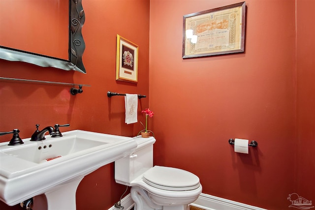 607 Goodwill Cir, Silas, AL 36919 - bathroom featuring a sink, toilet, and baseboards