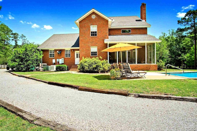 607 Goodwill Cir, Silas, AL 36919 - back of property featuring a chimney, brick siding, and a patio area