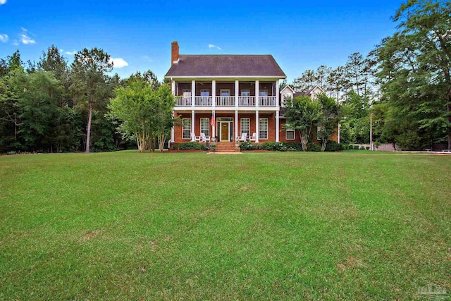 607 Goodwill Cir, Silas, AL 36919 - rear view of house with a balcony, a chimney, and a lawn