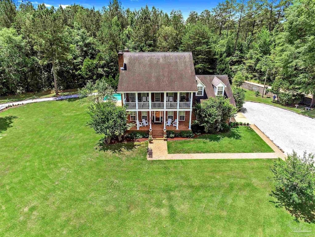607 Goodwill Cir, Silas, AL 36919 - view of front of house with a porch, a front lawn, a chimney, and driveway