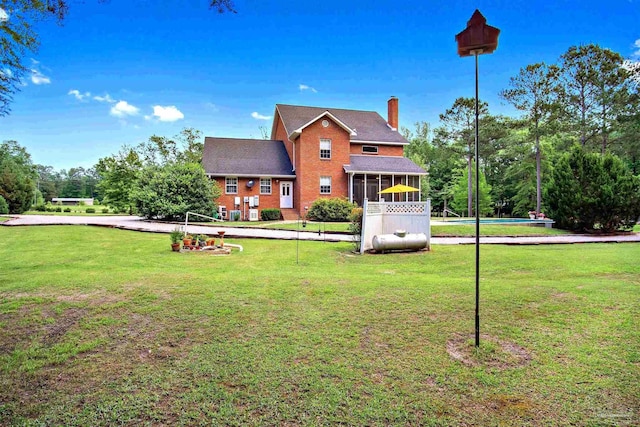 607 Goodwill Cir, Silas, AL 36919 - back of house with a chimney, a sunroom, a lawn, and brick siding
