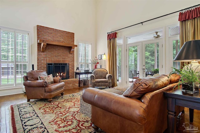 607 Goodwill Cir, Silas, AL 36919 - living area with plenty of natural light, hardwood / wood-style floors, french doors, a brick fireplace, and a high ceiling