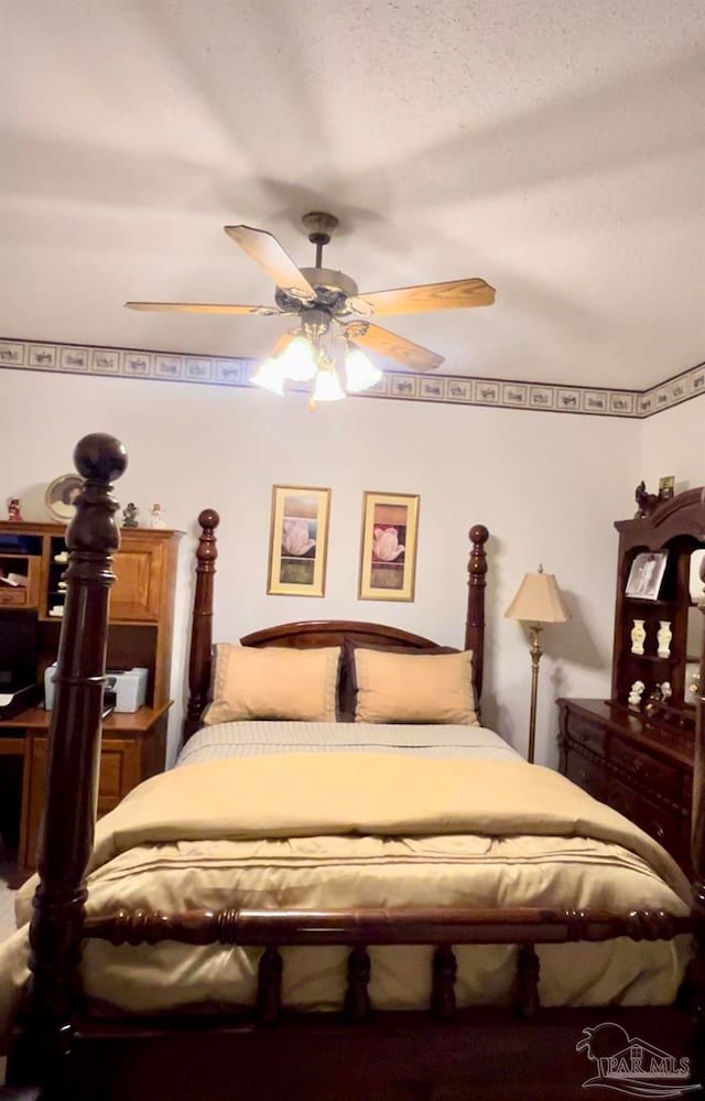 bedroom with a textured ceiling and ceiling fan