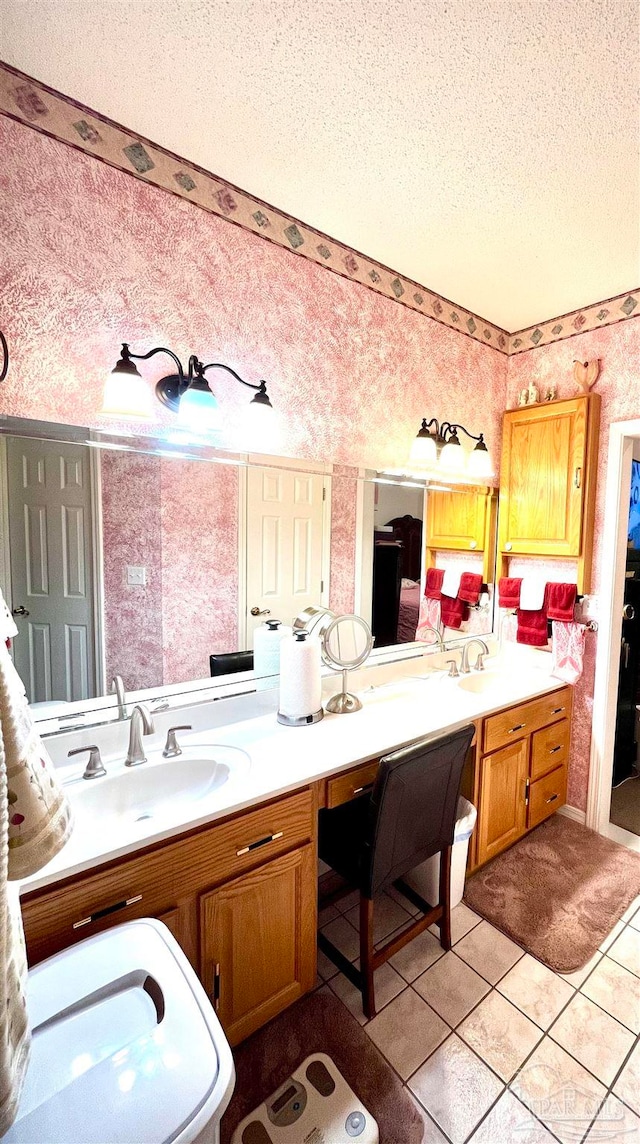 bathroom with tile patterned floors, vanity, and a textured ceiling