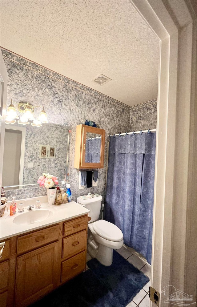 bathroom with walk in shower, tile patterned floors, a textured ceiling, toilet, and vanity