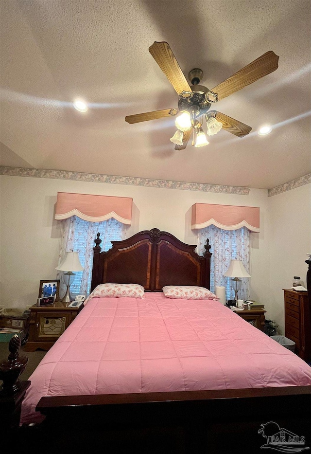 bedroom featuring a textured ceiling and ceiling fan