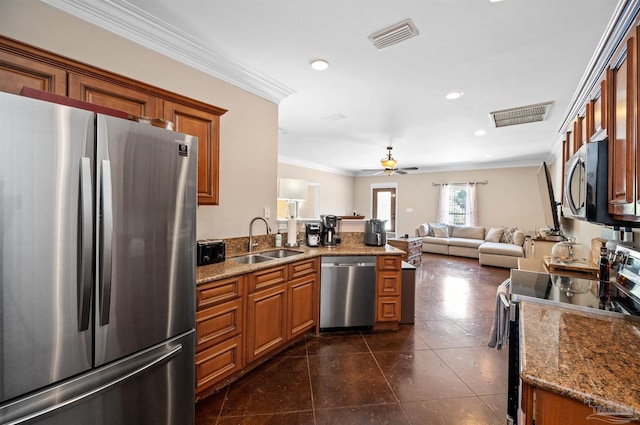 457 Boone Ln, Fairhope, AL 36532 - kitchen featuring appliances with stainless steel finishes, a sink, brown cabinetry, a peninsula, and crown molding