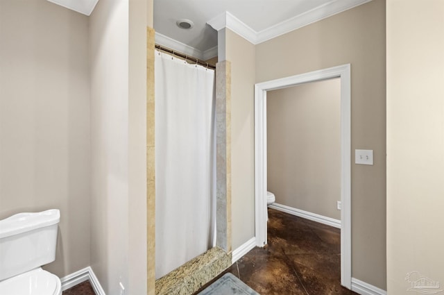 bathroom with toilet, ornamental molding, and a shower with curtain