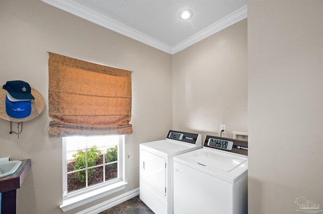 clothes washing area with crown molding and washing machine and dryer