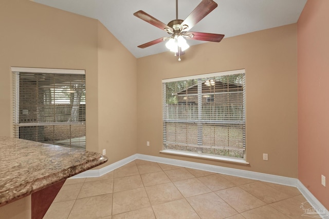 unfurnished dining area with ceiling fan, a wealth of natural light, and tile patterned floors