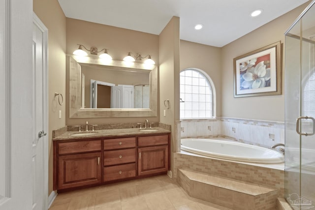 bathroom featuring plus walk in shower, tile patterned flooring, and vanity