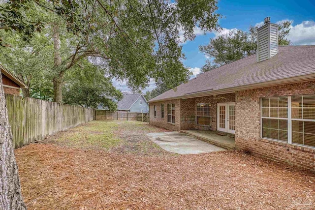 view of yard with french doors and a patio area