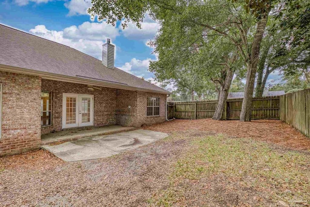 view of yard featuring french doors and a patio