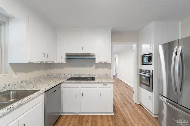 3481 Summit Blvd, Pensacola, FL 32503 - kitchen with appliances with stainless steel finishes, under cabinet range hood, light wood finished floors, white cabinetry, and light stone countertops