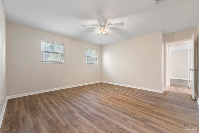 3481 Summit Blvd, Pensacola, FL 32503 - spare room featuring wood finished floors, ceiling fan, baseboards, and a textured ceiling